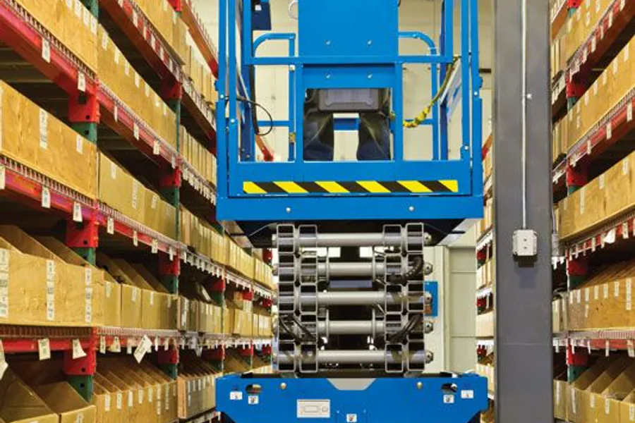 Scissor lift operating beside warehouse racking